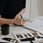Female designer working on fashion sketches in a creative studio environment.
